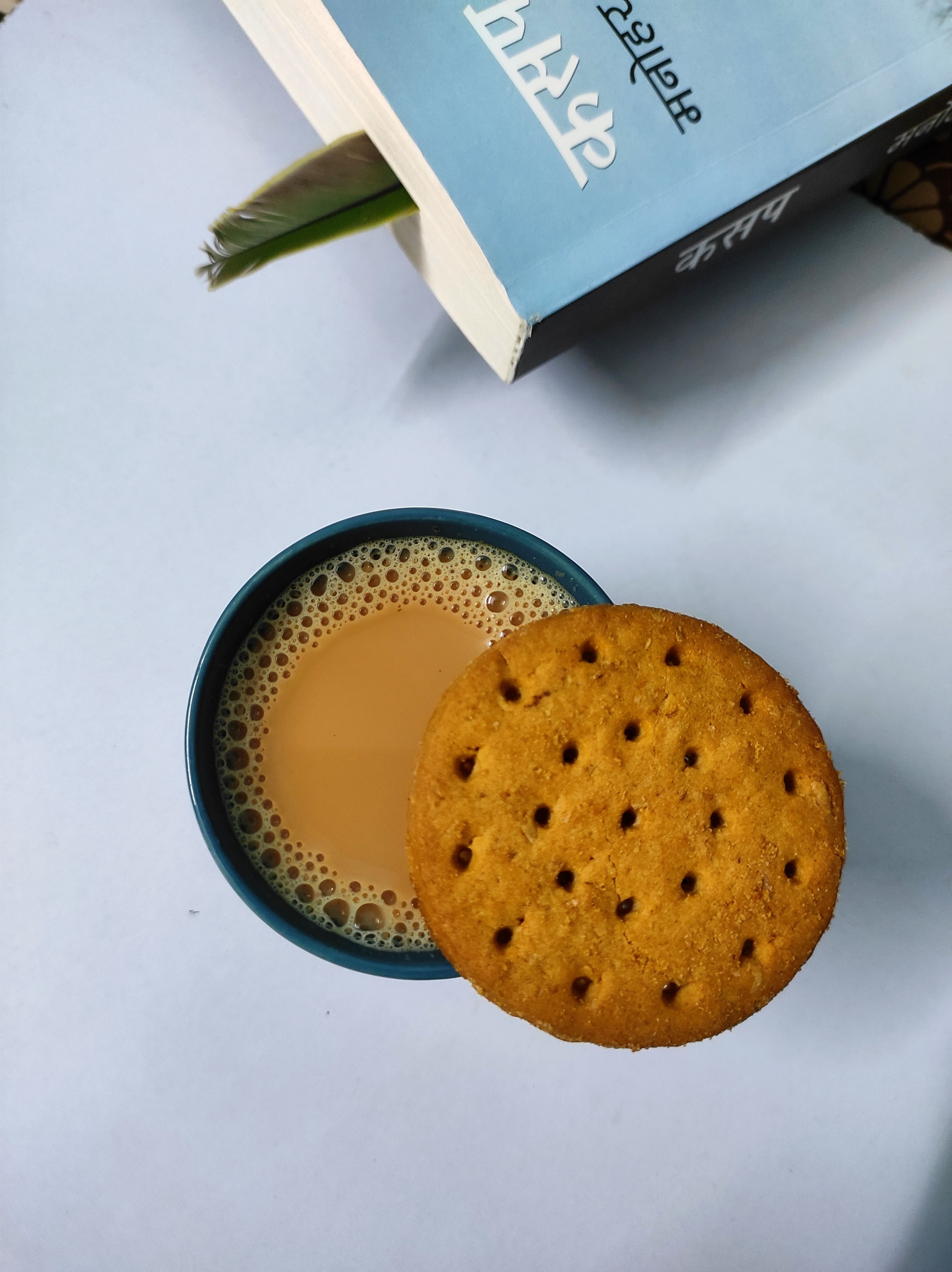 A cup of chai and a biscuit